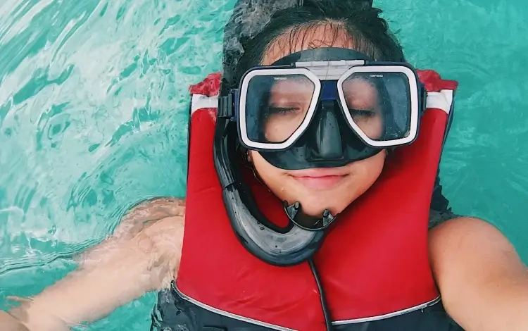 girl with life jacket when snorkeling